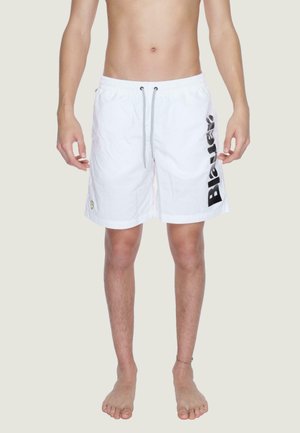 Pantaloni da nuoto bianchi con cintura elastica e cordino. Presentano una stampa del logo nera sul lato e un piccolo logo triangolare sull'orlo.