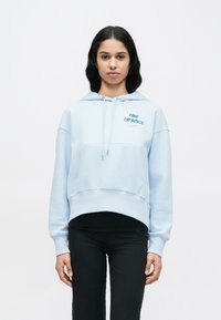 Φούτερ με κουκούλα σε ανοιχτό μπλε χρώμα και άνετη εφαρμογή, με τσέπη καγκουρό και λογότυπο Nike Athletics σε μπλε. Κατασκευασμένο από απαλό βαμβακερό μείγμα υφάσματος.