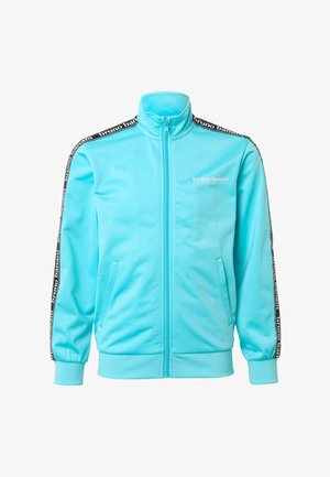 Jasnoniebieska rozpinana kurtka sportowa z wysokim kołnierzem, czarno-białe paski z logo na rękawach oraz logo "bruno banani" na lewej piersi.