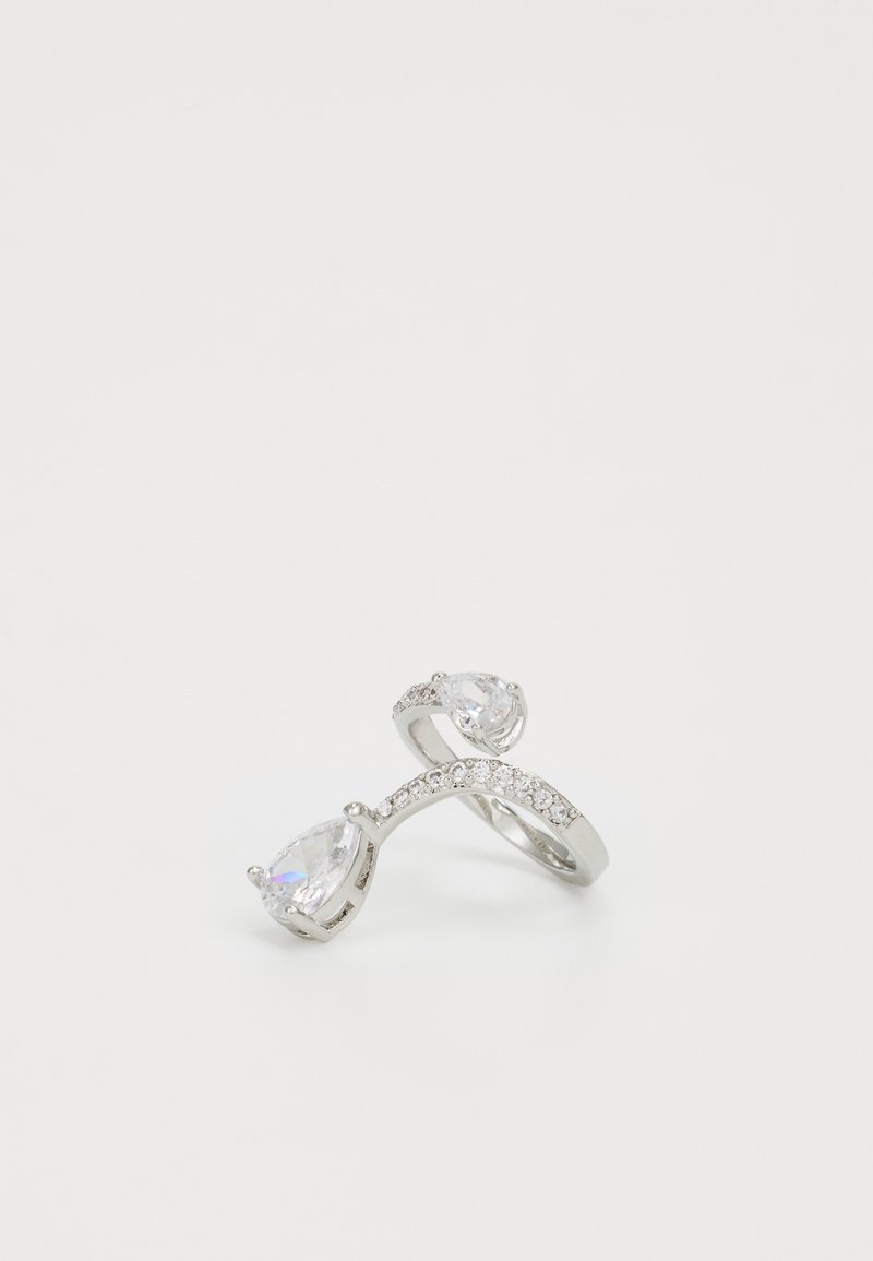 Sterling silver ring featuring two pear-shaped clear stones and a curved band adorned with small clear crystals.