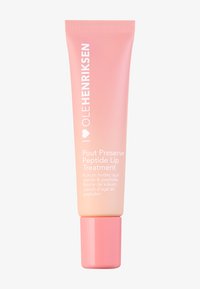 Brzoskwiniowa gradientowa tuba Ole Henriksen Pout Preserve Peptide Lip Treatment z różową nakrętką, z białym tekstem z przodu.