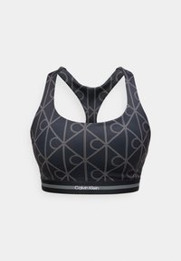 Μαύρο αθλητικό σουτιέν με γκρι γεωμετρικό σχέδιο από κουκκίδες, σχέδιο racerback και λογότυπο Calvin Klein στη ελαστική ταινία στο κάτω μέρος.
