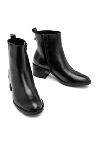 Czarne botki za kostkę wykonane z gładkiej skóry, z bocznym zamkiem błyskawicznym, okrągłym noskiem i niskim, warstwowym obcasem. Minimalistyczny design z pętelką.