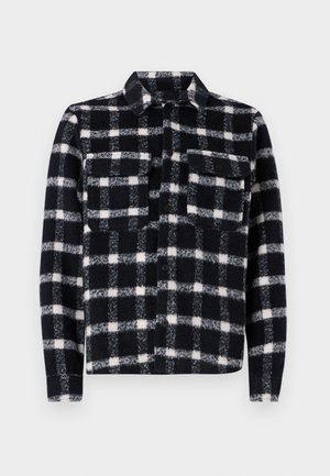 Sorte og hvide ternede flannel skjorte med to brystlommer, knaplukning foran og en struktureret krave; blød tekstur og robust materiale.