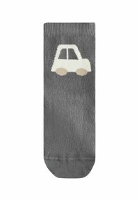 Chaussettes grises en tissu doux avec un motif de tracteur blanc et des roues beiges. Poignet côtelé classique et texture lisse.