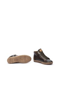 Zapatos altos de cuero marrón con un acabado texturizado, punta redondeada, cordones verdes y suela con patrón. Presenta un interior beige y tobillo ajustable.