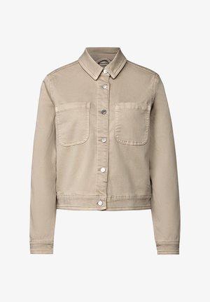 Giacca cropped beige in denim di cotone, con colletto a punta, bottoni a pressione argentati e due tasche sul petto. Texture liscia.