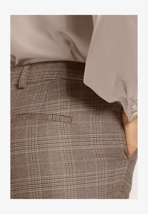 Gray plaid trousers with a textured fabric, featuring a back pocket and a fitted waistband, paired with a light gray blouse.