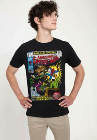 Black t-shirt featuring a comic book graphic of Spider-Man battling the Sinister Six, with colorful illustrations and text.