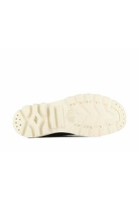Suela de zapatilla con una suela de goma crema; presenta un patrón de huella en zigzag y cortes circulares; textura limpia y suave.