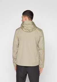 Light beige hooded jacket with a smooth texture, fitted design, and reflective accents on the sides. Back view shows seam details.