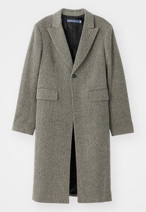Manteau à motif pied-de-poule dans des teintes de gris, avec un revers cranté, fermeture à un bouton et deux poches avant. Doublure intérieure.