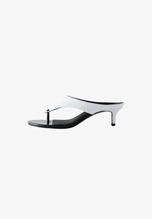 Weiße und schwarze Damen-String-Sandalen mit schlankem mittelhohem Absatz und minimalistischem Design.