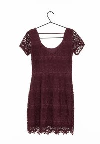 Burgunderröd spetsklänning med korta ärmar, med broderade blommönster och en scallopad fåll. Hänger på en svart metallhängare.