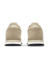 Beige suede sneakers with white accents and black rubber soles. Features prominent ASICS logo on the back and padded heel for comfort.