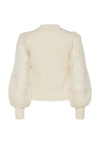 Cardigan couleur crème avec un corps en tricot côtelé et des manches bouffantes transparentes à pois. Un col rond et des poignets ajustés complètent le design.