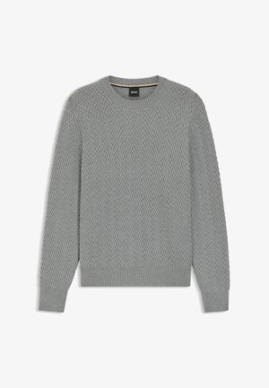 Pull en tricot gris avec un motif en chevrons, encolure ronde, et poignets et ourlet côtelés. Étiquette visible au col.