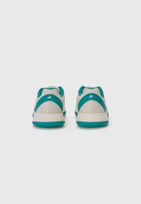 Sport shoes with a light gray mesh upper, turquoise accents, and textured rubber sole. Features padded collar and logo detail on heel.