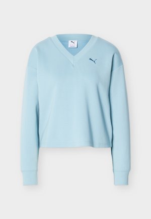 Hele sinine pika varrukaga lühendatud dressipluus V-kaelusega ja väikese tumesinise Puma logoga vasakul rinnal.