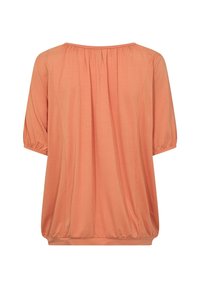 Blusa color durazno con un corte relajado, mangas cortas abullonadas y dobladillo elástico. Textura suave, diseño simple, sin patrones ni acentos.
