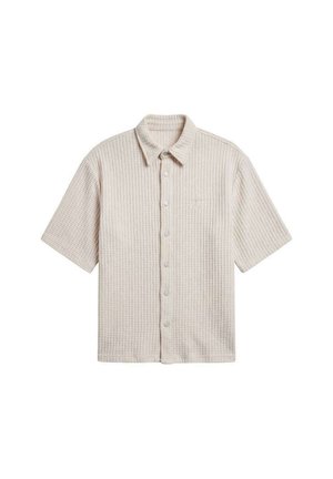 Chemise à manches courtes en tricot gaufré beige avec col et boutons pression à l'avant, présentée à plat sur un fond blanc.