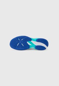 Semelle de chaussure avec un fond en caoutchouc bleu, présentant un motif texturé. Accents turquoise clair près de l'arche et une semelle intermédiaire blanche avec un détail de logo.