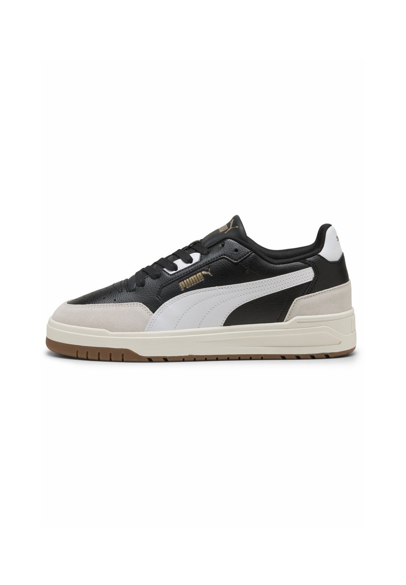 Black and white sneaker with suede and leather materials, featuring a rubber sole, lace-up closure, and gold logo accents.