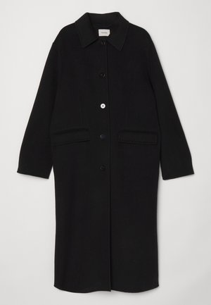 Casaco de lã preto com gola, botões frontais e dois grandes bolsos de chapa. Corte reto com mangas longas.