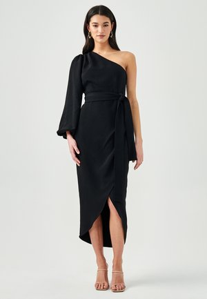 Black, one-shoulder dress with a fitted bodice, flowing bell sleeve, and a waist tie. Features a high slit on the left side. Smooth texture.