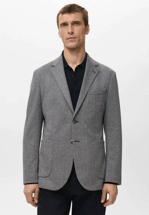 Grey herringbone blazer made of textured fabric, featuring a single button closure, notched lapels, and two front pockets.