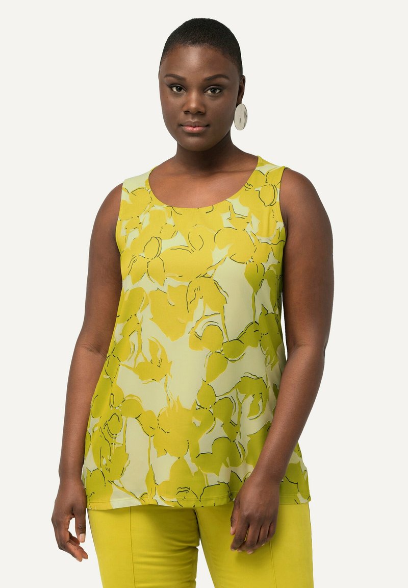 Blusa gialla senza maniche con un motivo floreale dalle linee verdi. Tessuto morbido, scollatura rotonda e vestibilità felice.