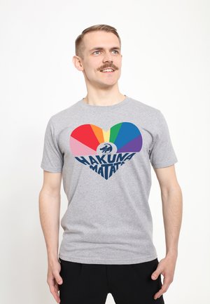 Gray t-shirt featuring a multicolored heart design with "HAKUNA MATATA" in dark blue text centered below the heart. Short sleeves, casual fit.