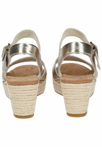 Metallic silver wedge sandals with a woven jute midsole and buckle strap. Soft suede insole, open back, and cross strap design.
