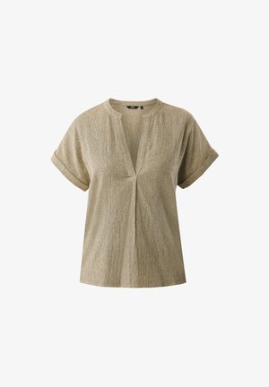 Beżowy top z krótkim rękawem i dekoltem w serek, o luźnym kroju, z fakturowanej tkaniny, z podwiniętymi mankietami. Ozdobiony zakładką na środku.