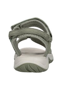 Gröna tygsandaler med justerbara remmar, en vadderad sula och en texturerad gummiyttersula för grepp och stabilitet.
