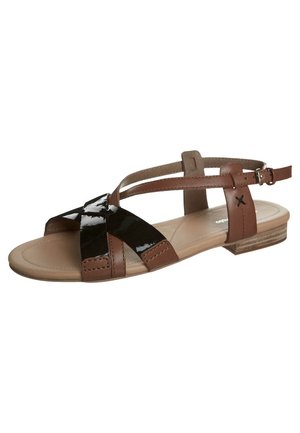 Brown and black patent leather sandals with a flat heel, featuring cross straps and an adjustable ankle strap. Smooth texture and simple design.