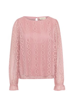 Blouse rose avec des manches longues en transparent, présentant un motif géométrique en losanges et une fermeture en trou de serrure à l'arrière. Texture douce avec des poignets froncés.