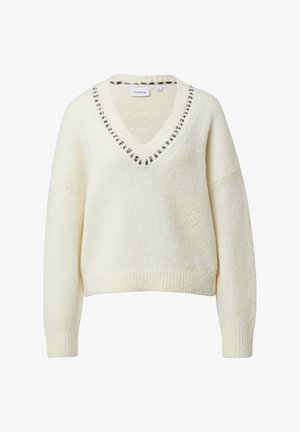 Kremowy sweter z dekoltem w serek, z teksturowanym splotem i ciemnobrązowym przeszyciem wokół kołnierza. Krótkie, luźne rękawy.