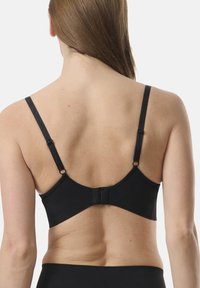 Svart bh med justerbara remmar, slät tygkvalitet och en krokupp-och-ögla-stängning bak. Enkel design utan synliga mönster eller accenter.