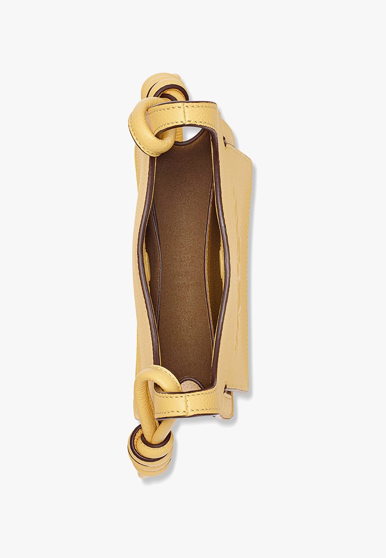 Gelbe Lederhandtasche mit geknoteten Griffen, offenes Oberteil, das ein braunes Innenfutter zeigt, von oben fotografiert vor einem schlichten Hintergrund.