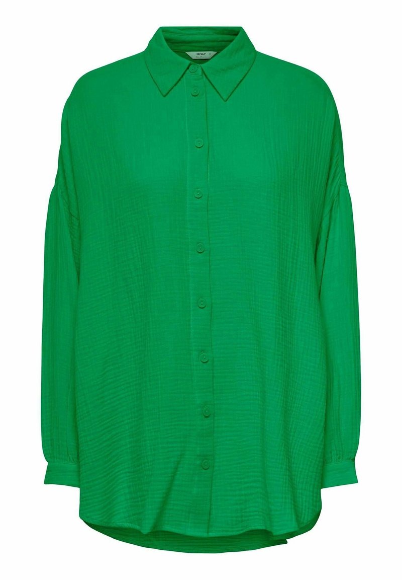 Chemise à manches longues verte à boutons avec un col pointu et un tissu légèrement texturé.