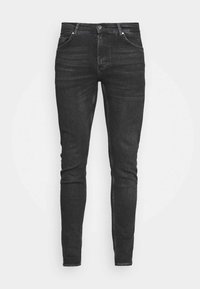 Svarta slim fit-jeans med en mjuk denimtextur, femficksdesign och knappstängning framtill. Subtila tvättade detaljer längs benen.