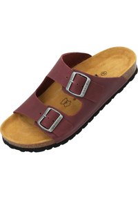 Sandalo in pelle marrone con due fibbie regolabili, insole in sughero e suola in gomma. Caratterizzato da un design aperto per una maggiore traspirabilità.