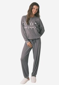 Gray loungewear set with long sleeves, featuring a geometric pattern and Mickey Mouse graphic. The pants have an elastic waistband and cuffs.