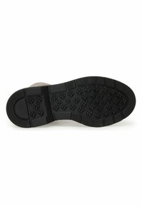 Black rubber shoe sole featuring a textured surface with molded flower patterns and structured grip areas, designed for traction and durability.