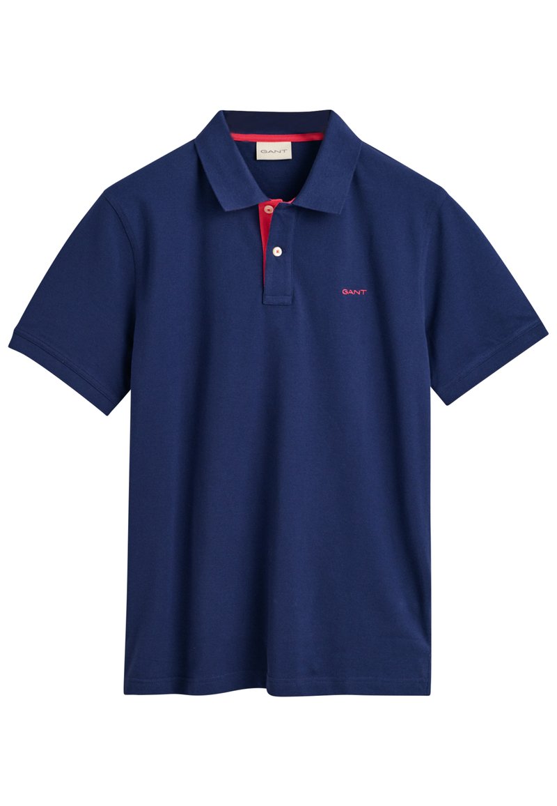 Navy Poloshirt aus Baumwolle mit klassischem Kragen, roten Knopfakzenten und gesticktem Logo auf der Brust. Kurze Ärmel und lockere Passform.
