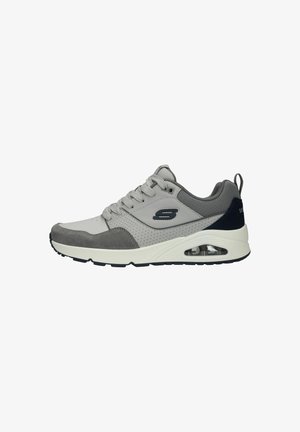 Gray athletic shoe with textured suede and mesh upper, white midsole, and visible air cushioning. Features laces and a rear pull tab.