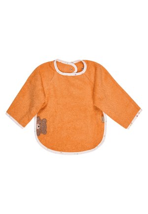 Orange long-sleeve baby bib with white trim, snap buttons at the neck, and a small bear face embroidery on the lower left side.