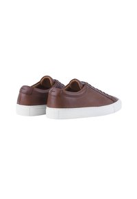 Brown leather sneakers with white rubber soles, featuring a smooth texture, rounded toe, and minimalistic design with laced detailing.