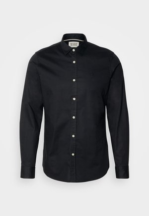 Sort langærmet skjorte lavet af bomuld, med knap-ned krave, front knaplukning og et lille broderet logo på brystet.